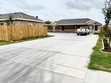 View of patio with concrete driveway