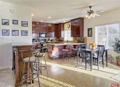 The dining area, kitchen, and an area for a wetbar