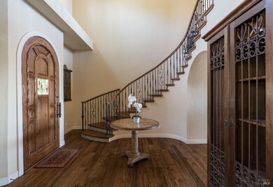 Lovely entry with parquet hardwood and archway to 