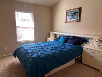 Bedroom featuring light colored carpet
