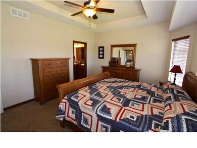 LARGE MASTER BEDRROM WITH CEILING FAN AND COFFERED