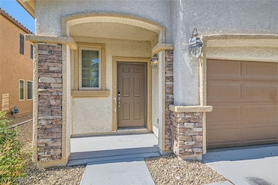 Property entrance featuring stucco siding and stone siding