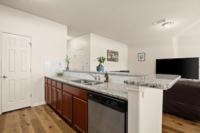 Kitchen featuring visible vents, open floor plan,