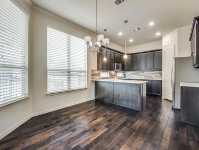 Kitchen with hanging light fixtures, dark hardwood