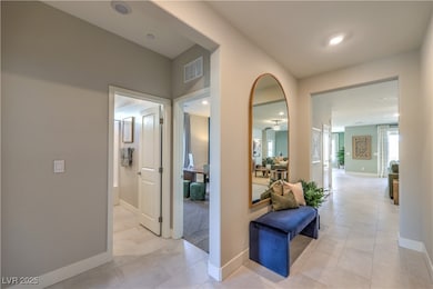 Corridor featuring baseboards, light tile patterne
