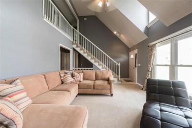 Large living room with tons of natural light from the picture window and dormers