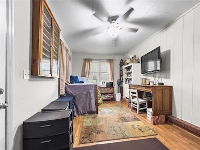 Office featuring ceiling fan and wood finished flo