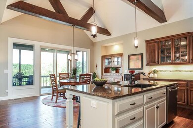 Warm open kitchen with view to PROTECTED WOODS beh