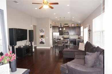 Living room with ceiling fan, dark wood finished 