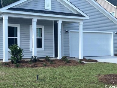 View of front facade featuring a garage, a porch, 
