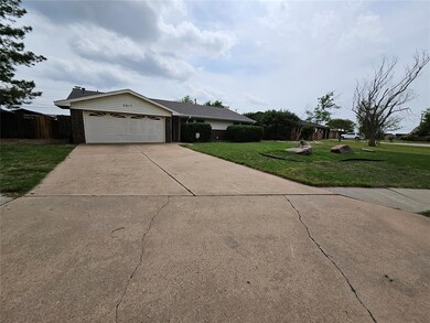 Single story home with brick siding, fence, a gara