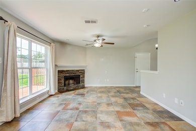 Living Room also has curtains and a ceiling fan.  The fireplace has also been updated with ledger rock.  Recent updates also include double pane windows for more energy efficiecy.