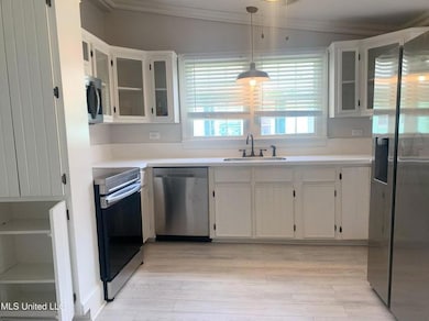 Kitchen with original restored cabinets.