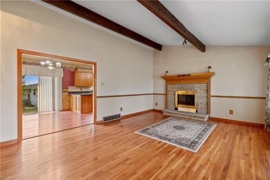 Hardwood floored living room featuring lofted ceil