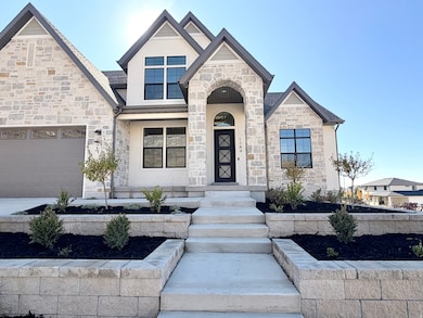 View of front of home with stone siding and stucco siding