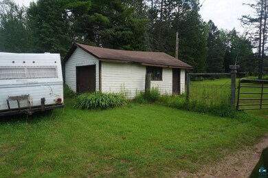 View of outbuilding with a yard