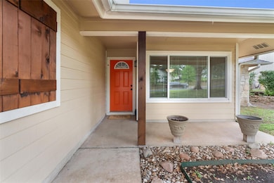 View of exterior entry featuring covered porch