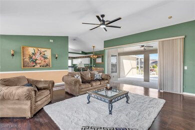 Living room featuring a notable chandelier, dark h