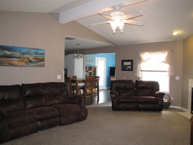 Living room opens to dining area and kitchen