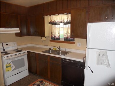 Kitchen features brand-new stove and refrigerator.