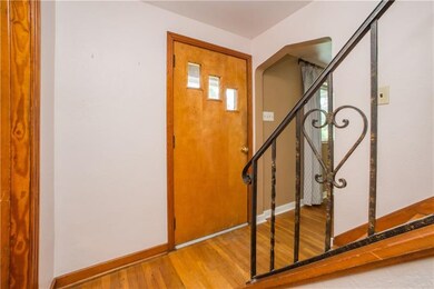 Hardwood flooring is found in the foyer. The curve