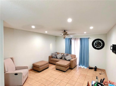 Living room with recessed lighting, a ceiling fan, and light tile patterned floors