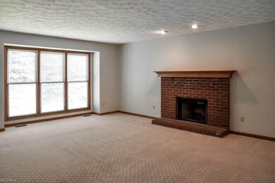Family room with a brick fireplace.