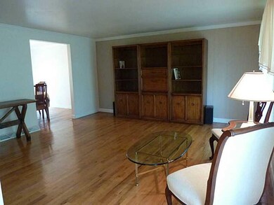 Living Room. Beautiful rich hardwood floors show o