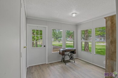 This quaint room would make a great sunroom, office space, or tea/ reading room. It's located just off the kitchen and has a side door leading to the outside.