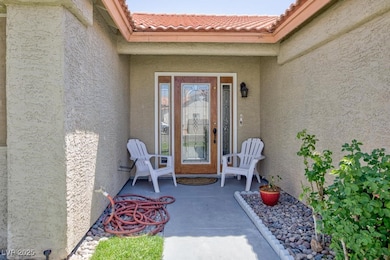 Property entrance with stucco siding and a tile roof
