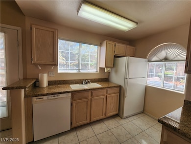 Kitchen featuring white appliances, a sink, health