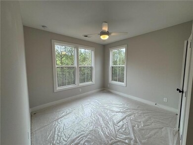 Empty room with visible vents, baseboards, and ceiling fan