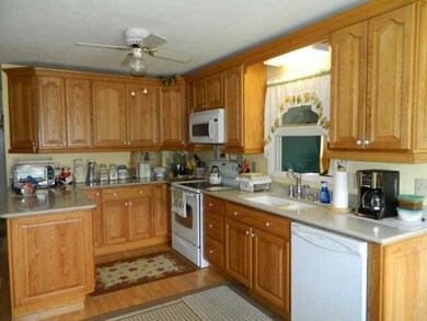 Large Eat-in Kitchen w/ Silestone Countertops, Craftmaid Cabinents & Wood Flooring.
