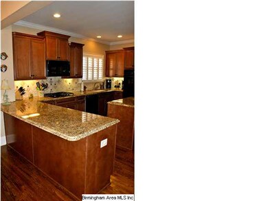 Upscale Kitchen has hardwood floors, granite count