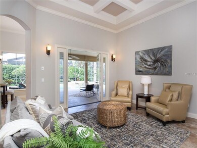 Formal Living Room with French Doors to back lanai, crown molding and coffered ceilings.