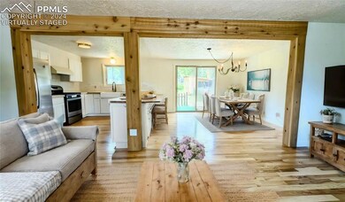 Living room featuring sink, a texturedceiling, lig