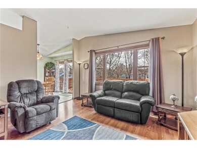 The living room features vaulted ceilings and hard