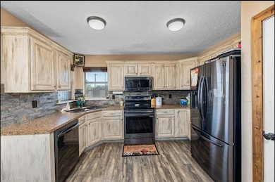 Kitchen with stainless steel appliances, dark wood