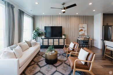 Living room with wood finished floors, recessed lighting, and ceiling fan