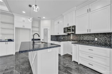 Kitchen with dark marble finish flooring, open shelves, dark stone countertops, backsplash, and recessed lighting