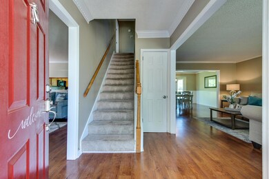 Entry opens to den on one side, living room on the other