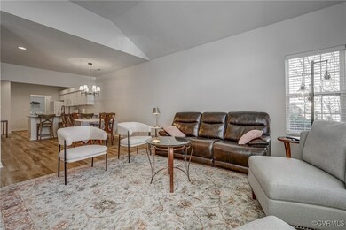 Living area with a chandelier, light wood-style fl