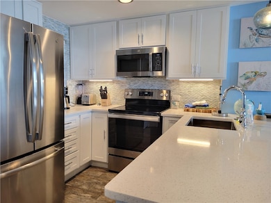 The full kitchen features stainless appliances.