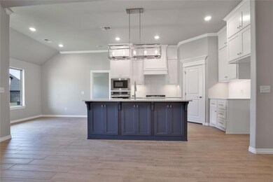 Kitchen with an island with sink, light hardwood /