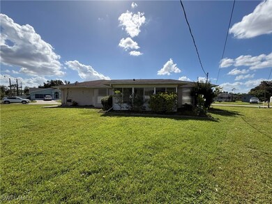 Rear view of property with a yard