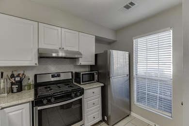 Kitchen with tasteful backsplash, visible vents, s