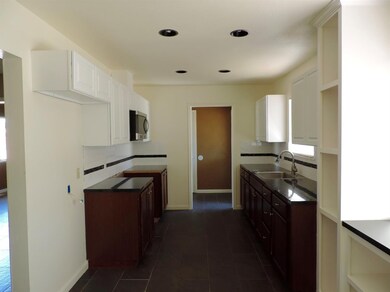 Clean and bright kitchen with granite counters and