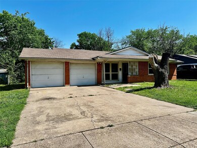 Ranch-style home with a shingled roof, a garage, b