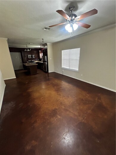 Unfurnished living room with concrete floors, a ce