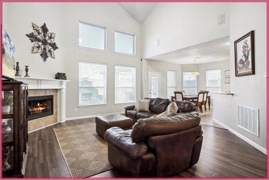 Living room with a fireplace, dark wood-type floor